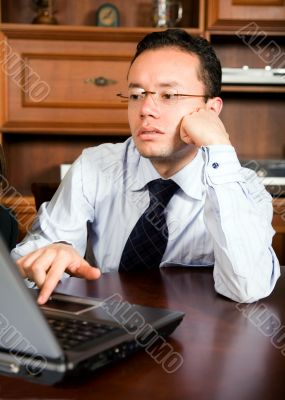 business man in his office on a laptop
