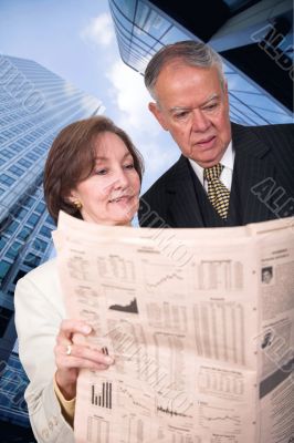 business partners reading financial paper