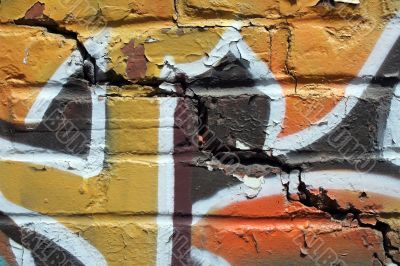 Bright graffiti on a cracked brick wall