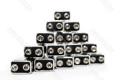 Nine volt batteries forming a triangle