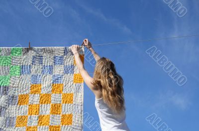 Longhaired girl and bright laundry