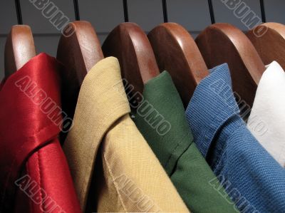 Colourful shirts on wooden hangers