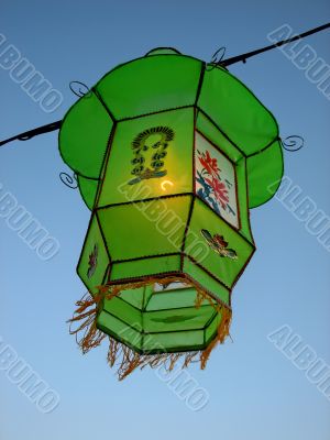 Cozy light of a green Chinese lantern