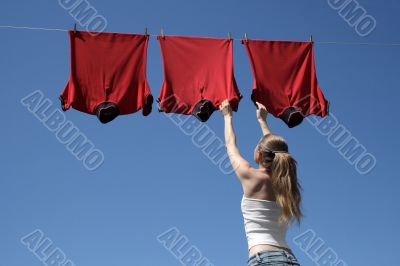 Girl, blue sky and red laundry
