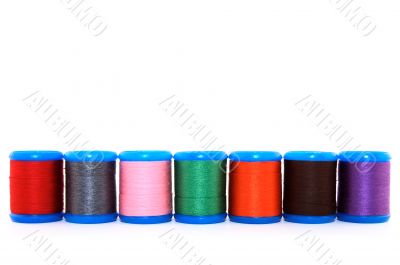 Row of colorful thread spools