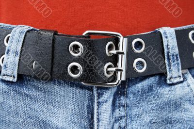 Black leather belt and blue jeans