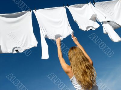 Longhaired girl, blue sky and white laundry