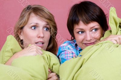 Two girl watching a scary movie