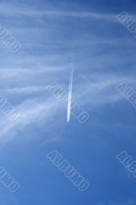 Jet airplane crossing the sky like a comet