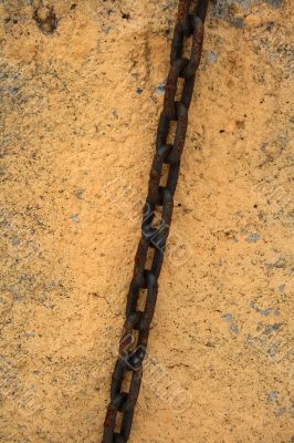 Rusty chain on a stone wall Rusty chain on a stone wall