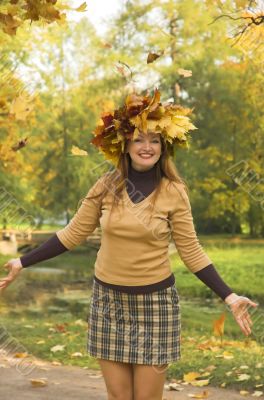 The cheerful girl on rest in autumn park