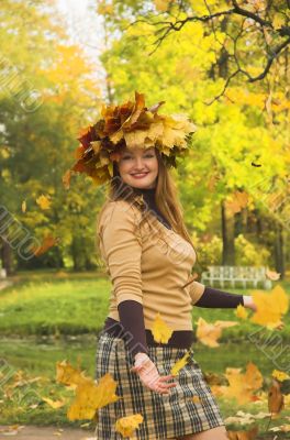 The cheerful girl on rest in autumn park
