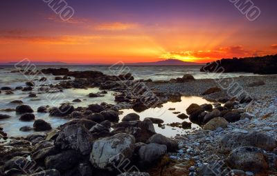 Glorious sunset over rocky seascape