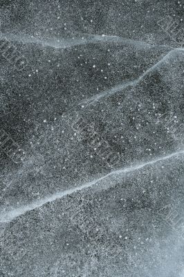 Grainy snow covering cracked ice
