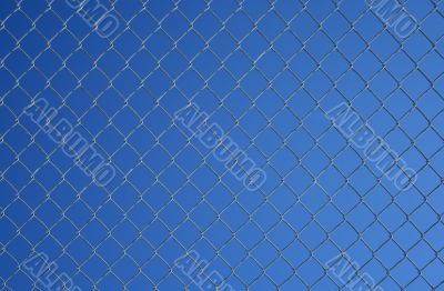 Chain link fence against the blue sky