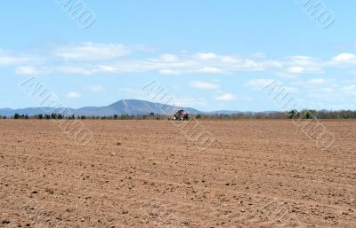 Tractor plowing land in spring