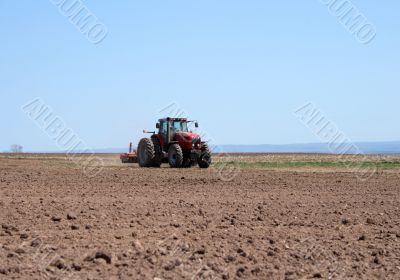 Tractor plowing land
