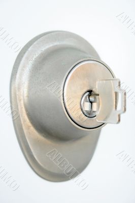 Metallic door lock with a key