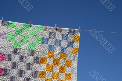 Patchwork counterpane on a clothes-line