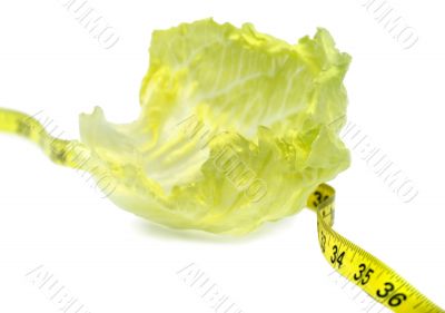Healthy dieting - lettuce and measuring tape.