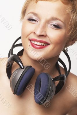 Close up portrait of young and attractive party girl with headph