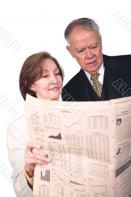 business partners reading financial paper