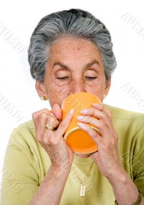 elderly woman drinking a hot drink