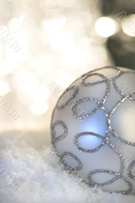 Christmas bauble with light in background