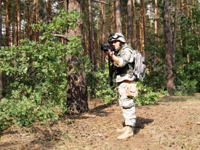 Soldier aiming in the woodland