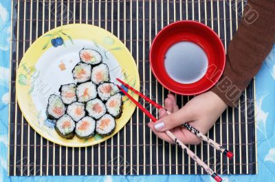 To have a meal Sushi on dinner with Chopsticks