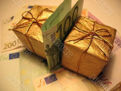 Two golden christmas gift box and money