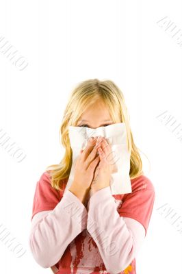 Young blond girl sneezing in the handkerchief