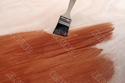 Newly painted wooden surface and brush