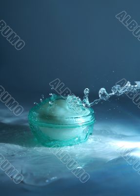 Bank with a cream in sparks of water