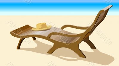 Chaise lounge and straw hat on coast of ocean