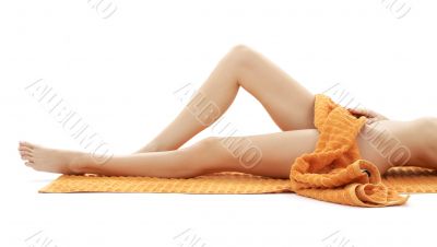 long legs of relaxed lady with orange towel