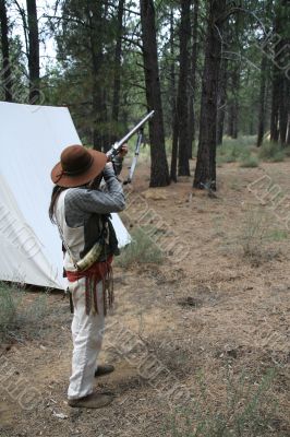 Mountain man preparing to fire