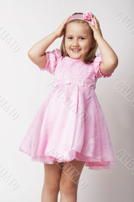 Nice young girl in pink on light background
