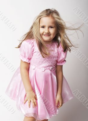 Nice young girl in pink on light background