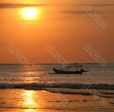 Drifting boat on a sunset