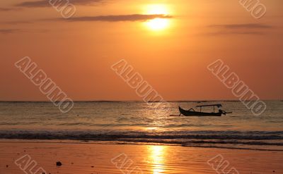 Drifting boat on a sunset