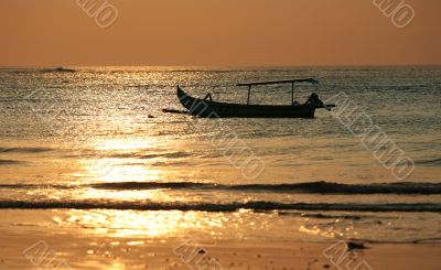 Drifting boat on a sunset