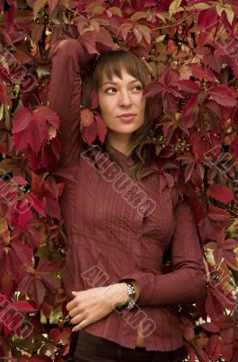 The beautiful girl in red leaves