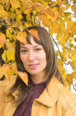 The beautiful girl in yellow  leaves