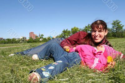 little pretty girl and mother in spring time