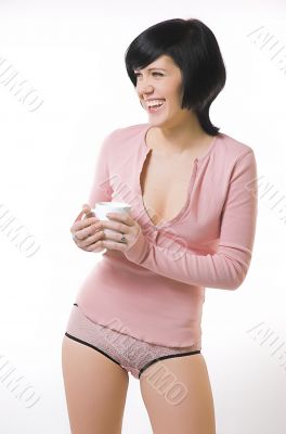 The girl in pink linen with a cup in hands The girl in pink linen with a cup in hands
