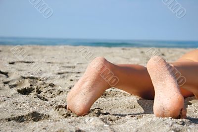 close up of bare feet on beach