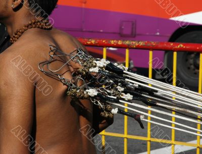 Man with hooks at back