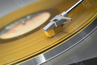 Yellow vinyl record on turntable - tilted view