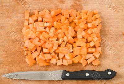 carrots and knife on a breadboard